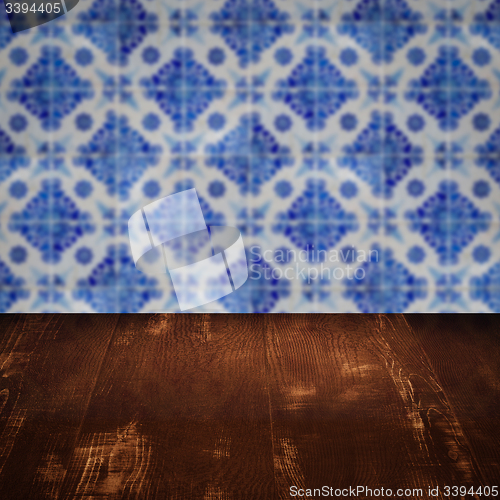 Image of Wood table top and blur vintage ceramic tile pattern wall