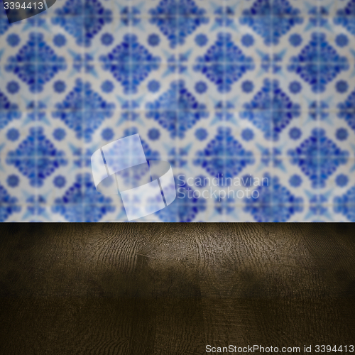 Image of Wood table top and blur vintage ceramic tile pattern wall