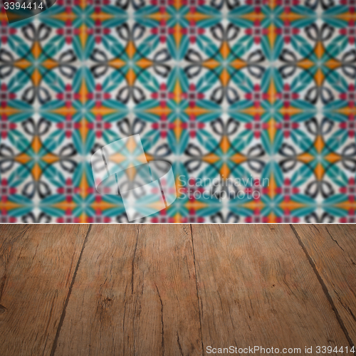 Image of Wood table top and blur vintage ceramic tile pattern wall