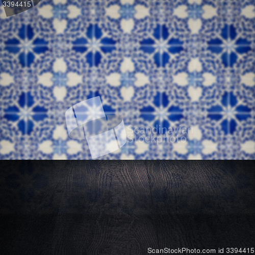 Image of Wood table top and blur vintage ceramic tile pattern wall