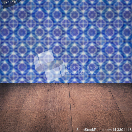 Image of Wood table top and blur vintage ceramic tile pattern wall