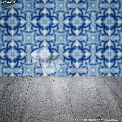 Image of Wood table top and blur vintage ceramic tile pattern wall