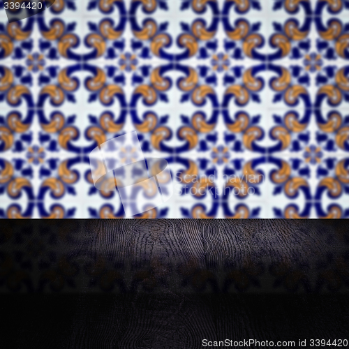 Image of Wood table top and blur vintage ceramic tile pattern wall