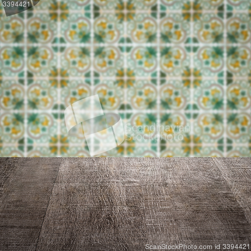 Image of Wood table top and blur vintage ceramic tile pattern wall