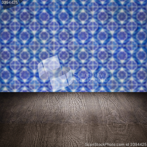 Image of Wood table top and blur vintage ceramic tile pattern wall
