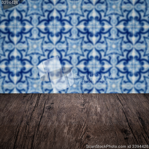 Image of Wood table top and blur vintage ceramic tile pattern wall