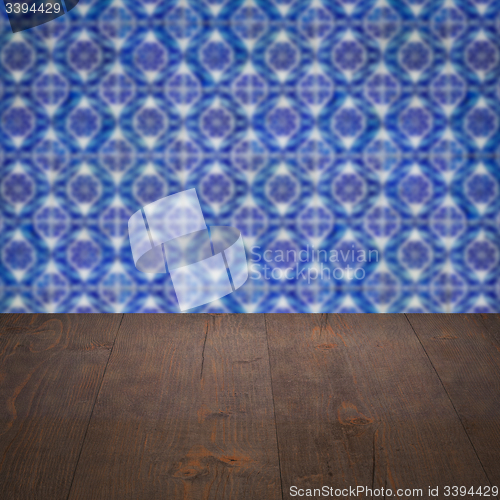 Image of Wood table top and blur vintage ceramic tile pattern wall