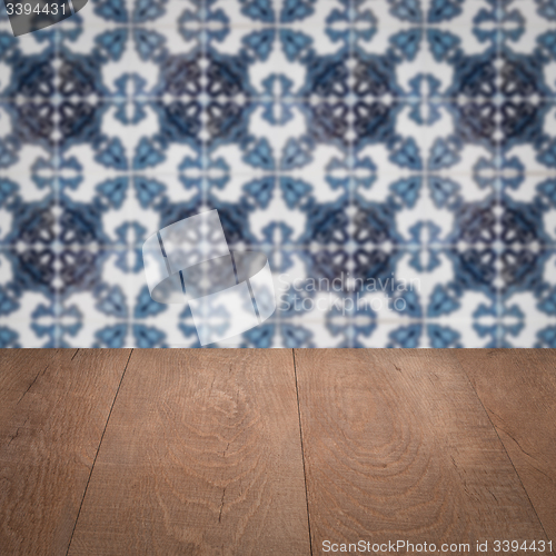 Image of Wood table top and blur vintage ceramic tile pattern wall
