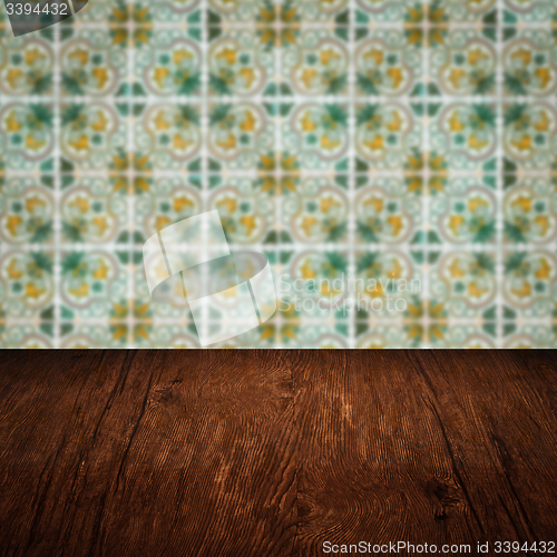 Image of Wood table top and blur vintage ceramic tile pattern wall