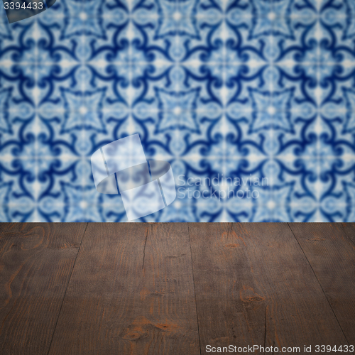 Image of Wood table top and blur vintage ceramic tile pattern wall