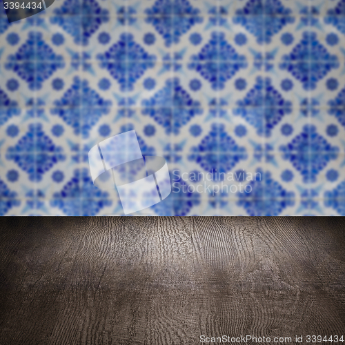 Image of Wood table top and blur vintage ceramic tile pattern wall