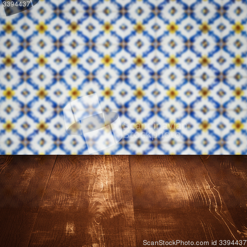 Image of Wood table top and blur vintage ceramic tile pattern wall