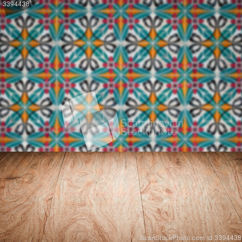 Image of Wood table top and blur vintage ceramic tile pattern wall