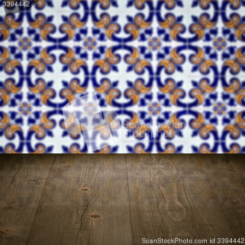 Image of Wood table top and blur vintage ceramic tile pattern wall