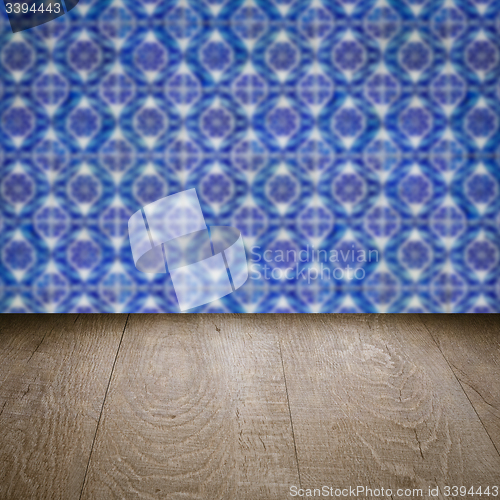 Image of Wood table top and blur vintage ceramic tile pattern wall