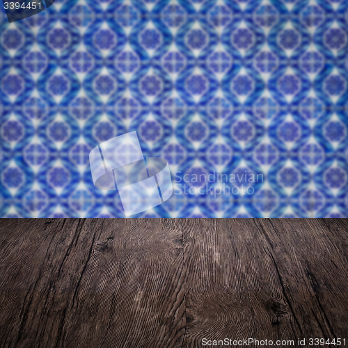 Image of Wood table top and blur vintage ceramic tile pattern wall