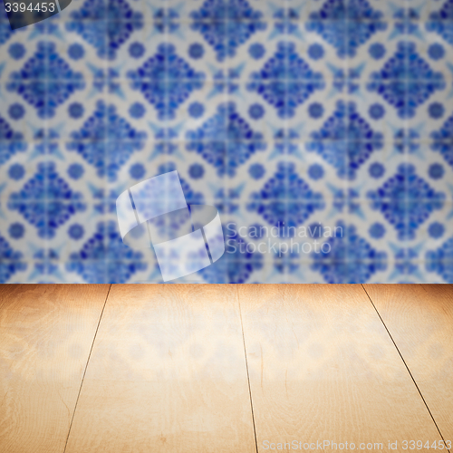 Image of Wood table top and blur vintage ceramic tile pattern wall