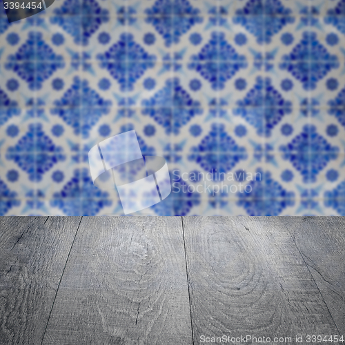 Image of Wood table top and blur vintage ceramic tile pattern wall