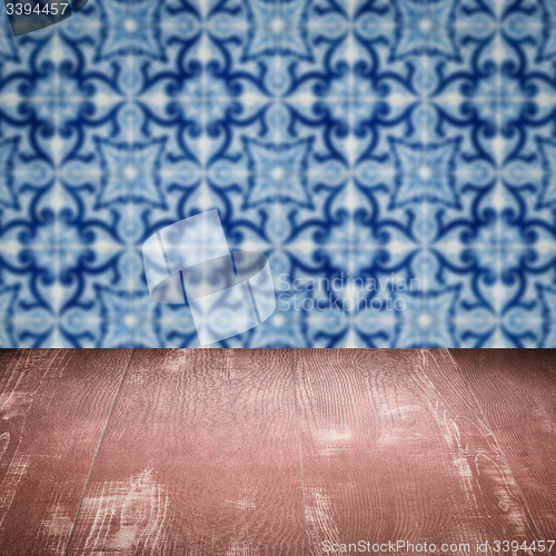 Image of Wood table top and blur vintage ceramic tile pattern wall