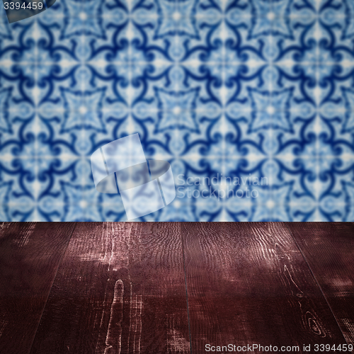 Image of Wood table top and blur vintage ceramic tile pattern wall