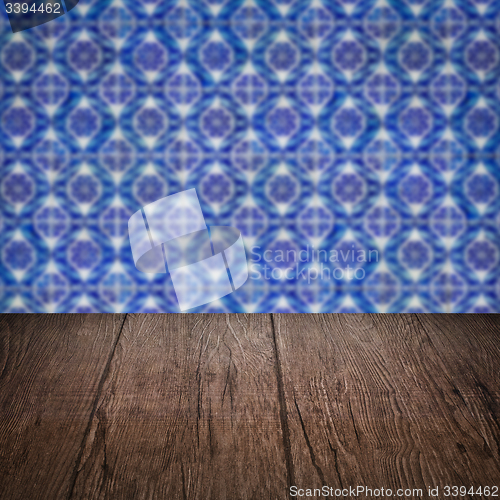Image of Wood table top and blur vintage ceramic tile pattern wall