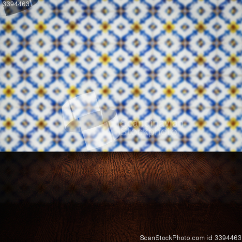 Image of Wood table top and blur vintage ceramic tile pattern wall