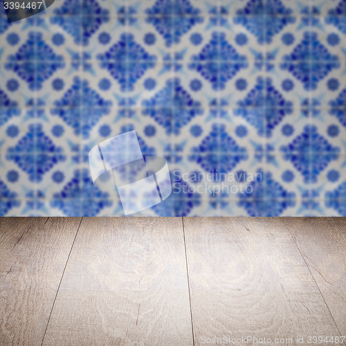 Image of Wood table top and blur vintage ceramic tile pattern wall