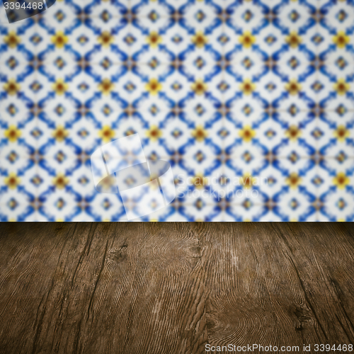 Image of Wood table top and blur vintage ceramic tile pattern wall