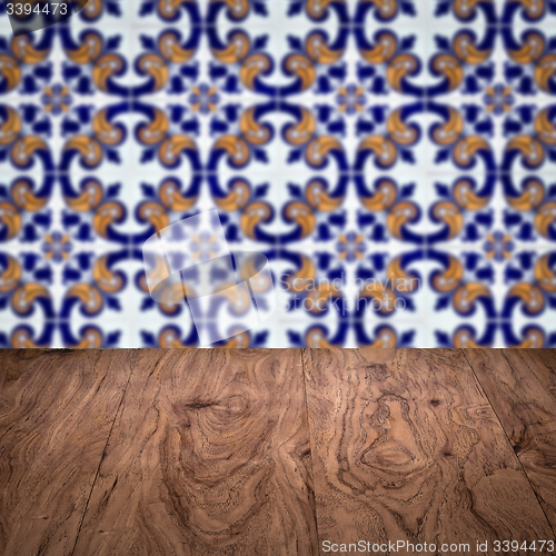 Image of Wood table top and blur vintage ceramic tile pattern wall