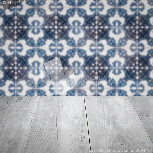Image of Wood table top and blur vintage ceramic tile pattern wall