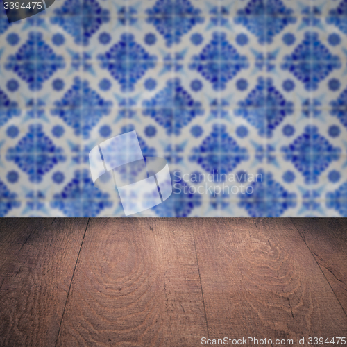 Image of Wood table top and blur vintage ceramic tile pattern wall