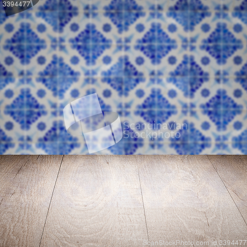 Image of Wood table top and blur vintage ceramic tile pattern wall