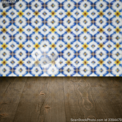 Image of Wood table top and blur vintage ceramic tile pattern wall