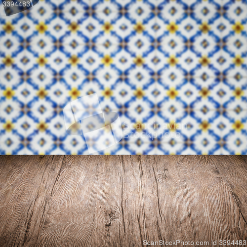 Image of Wood table top and blur vintage ceramic tile pattern wall
