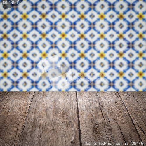 Image of Wood table top and blur vintage ceramic tile pattern wall
