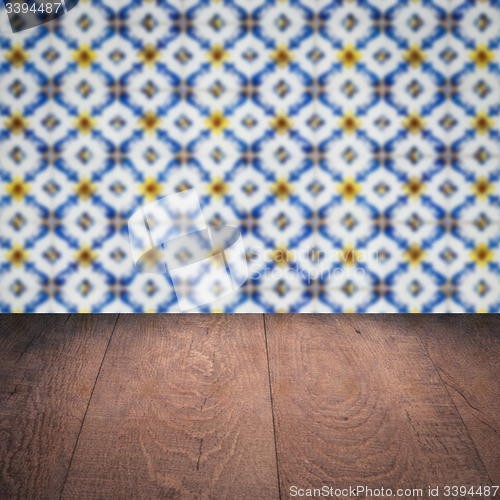 Image of Wood table top and blur vintage ceramic tile pattern wall
