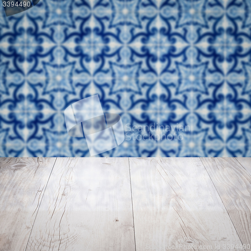 Image of Wood table top and blur vintage ceramic tile pattern wall