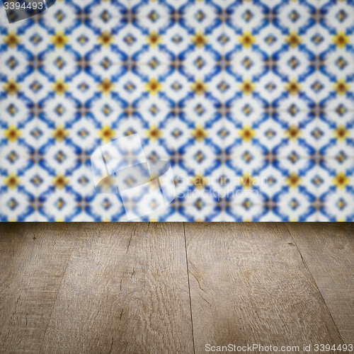 Image of Wood table top and blur vintage ceramic tile pattern wall