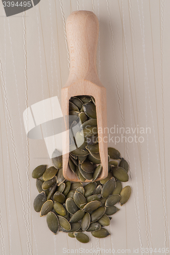 Image of Wooden scoop with pumpkin seeds