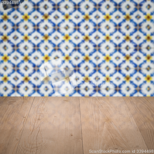 Image of Wood table top and blur vintage ceramic tile pattern wall