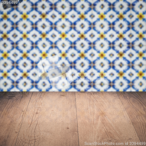 Image of Wood table top and blur vintage ceramic tile pattern wall