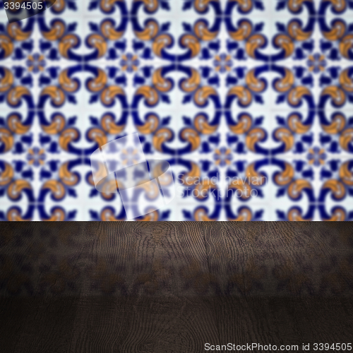 Image of Wood table top and blur vintage ceramic tile pattern wall