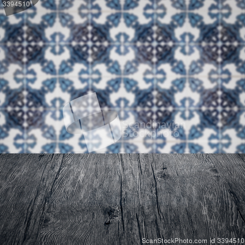 Image of Wood table top and blur vintage ceramic tile pattern wall