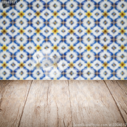 Image of Wood table top and blur vintage ceramic tile pattern wall