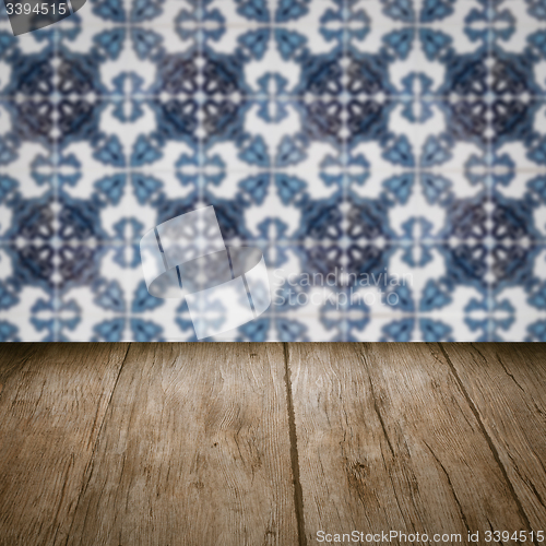 Image of Wood table top and blur vintage ceramic tile pattern wall