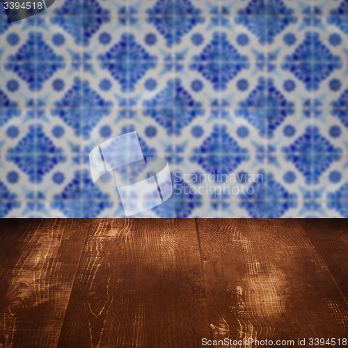 Image of Wood table top and blur vintage ceramic tile pattern wall