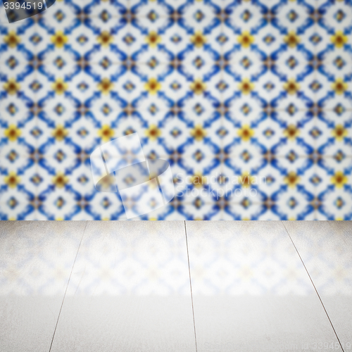 Image of Wood table top and blur vintage ceramic tile pattern wall