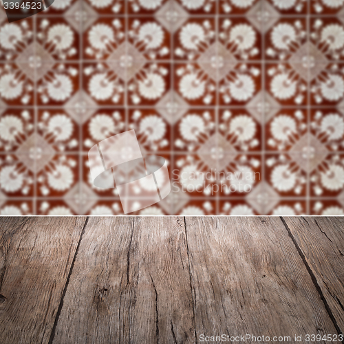 Image of Wood table top and blur vintage ceramic tile pattern wall