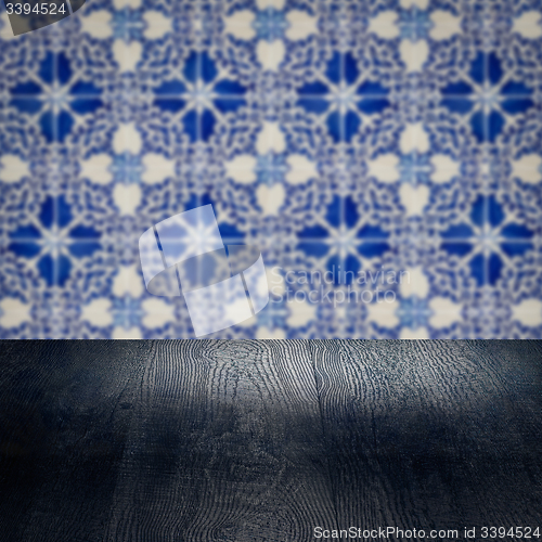 Image of Wood table top and blur vintage ceramic tile pattern wall