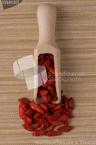 Image of Wooden scoop with dry red goji berries